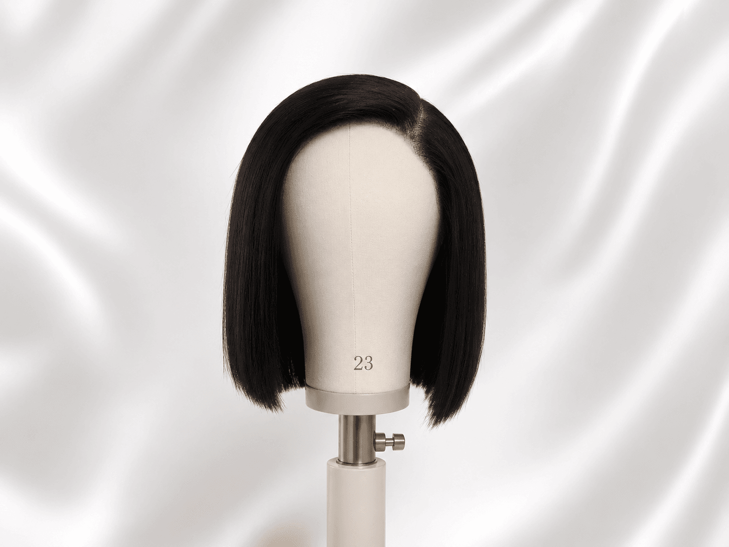 12-inch black bob wig after refresh on a mannequin head, sleek and polished